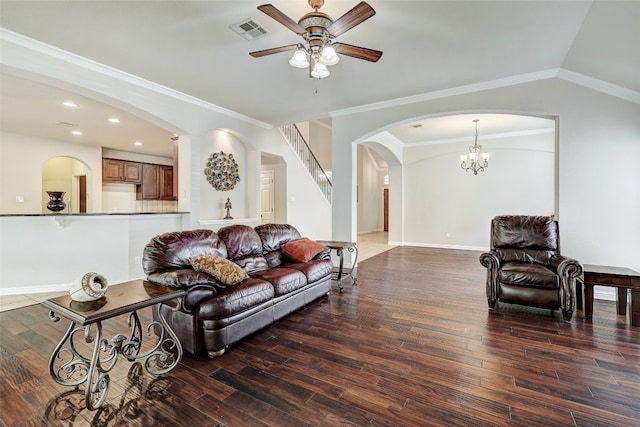 living room with ornamental molding, dark wood-type flooring, ceiling fan with notable chandelier, and vaulted ceiling