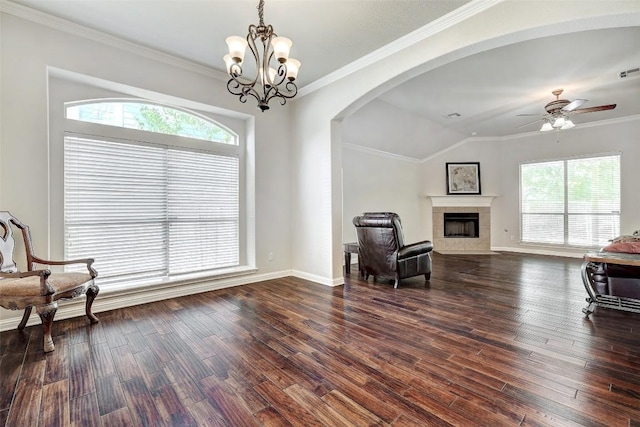 1102 Canyon Maple Rd, Pflugerville, TX 78660 - living area with a ceiling fan, a fireplace, arched walkways, dark wood-style flooring, and ornamental molding