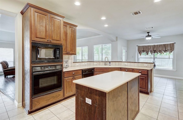 kitchen with visible vents, black appliances, tasteful backsplash, a peninsula, and light tile patterned floors