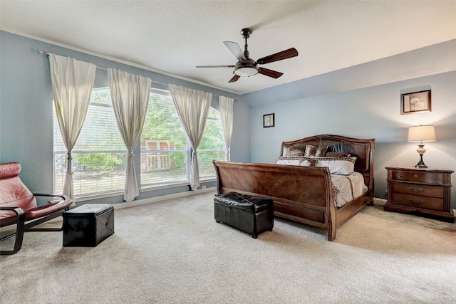 bedroom featuring a textured ceiling, ceiling fan, carpet floors, and lofted ceiling