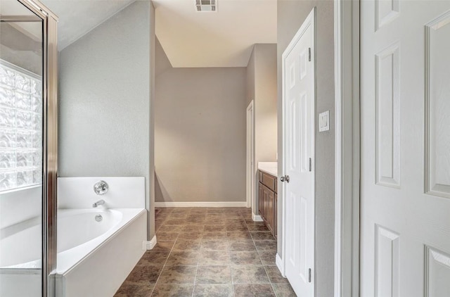 1102 Canyon Maple Rd, Pflugerville, TX 78660 - bathroom featuring a bath, vanity, and baseboards