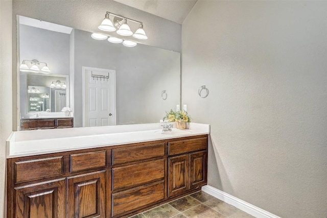 1102 Canyon Maple Rd, Pflugerville, TX 78660 - bathroom featuring baseboards, vanity, and a textured wall