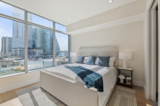 bedroom featuring hardwood / wood-style flooring and multiple windows