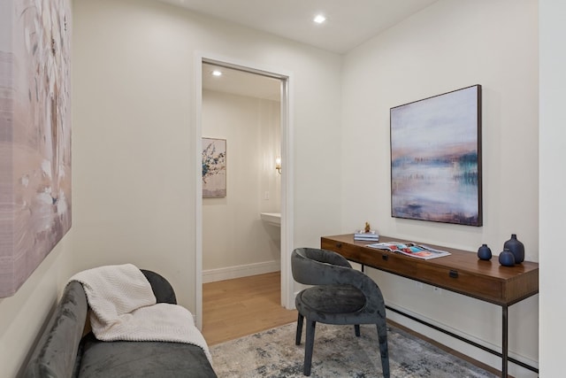 office area with light wood-type flooring and a baseboard heating unit