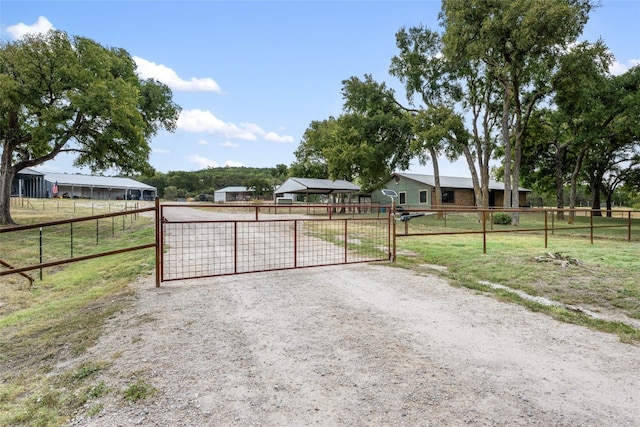 view of gate with a rural view