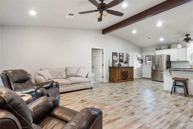 living room with ceiling fan, light wood-type flooring, and vaulted ceiling with beams