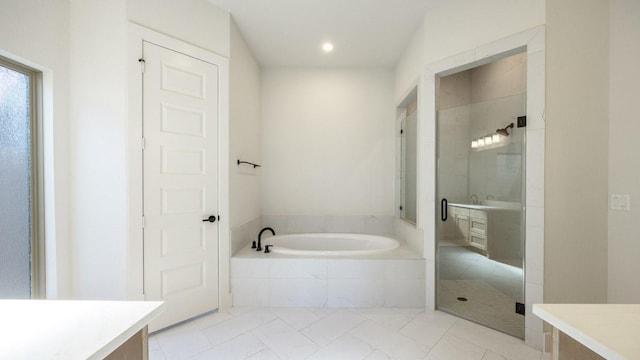 full bathroom featuring a stall shower, a garden tub, vanity, and recessed lighting