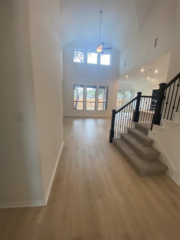 interior space featuring wood-type flooring and high vaulted ceiling