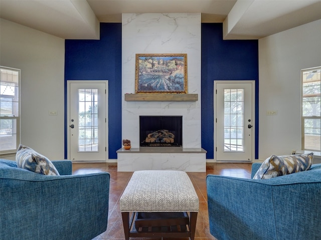 living room featuring a high end fireplace