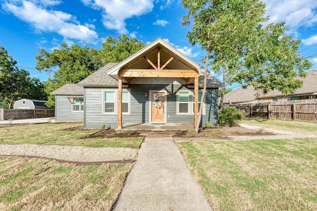 bungalow-style home with a front lawn