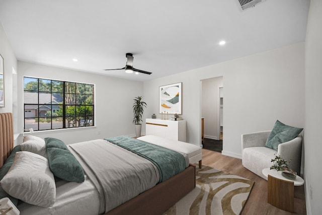 bedroom with light hardwood / wood-style flooring and ceiling fan