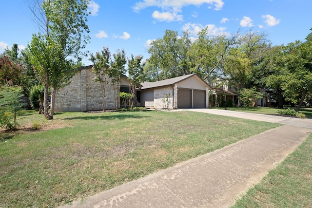 single story home featuring a front lawn and a garage