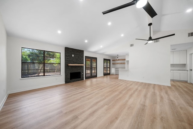 unfurnished living room with a fireplace, high vaulted ceiling, light hardwood / wood-style flooring, and ceiling fan