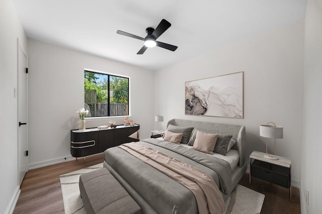 bedroom with hardwood / wood-style flooring and ceiling fan