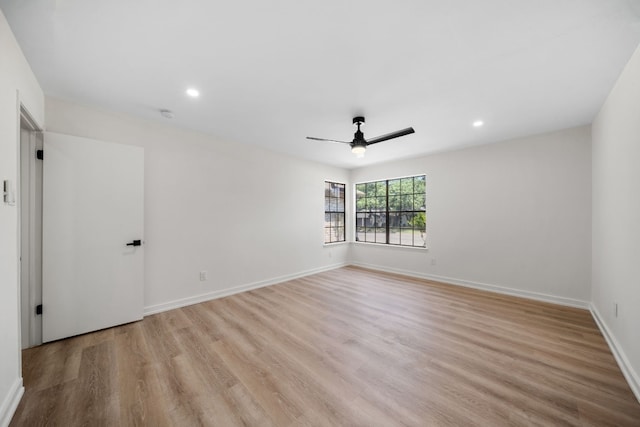 spare room with light wood-type flooring and ceiling fan