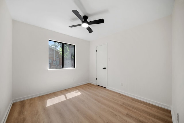 empty room featuring ceiling fan and light hardwood / wood-style floors