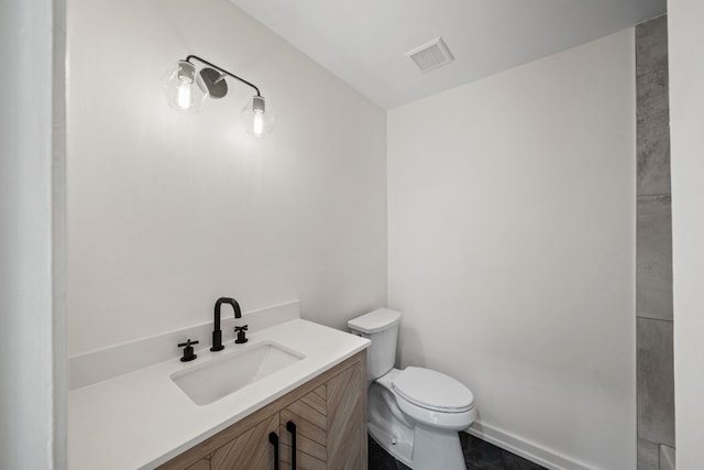 bathroom with toilet and vanity