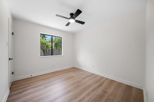 spare room featuring light hardwood / wood-style flooring and ceiling fan