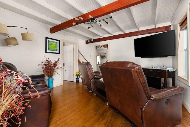 living room with beamed ceiling and dark wood-type flooring