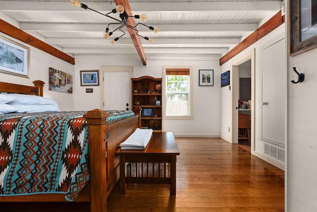 bedroom with beam ceiling and dark wood-type flooring