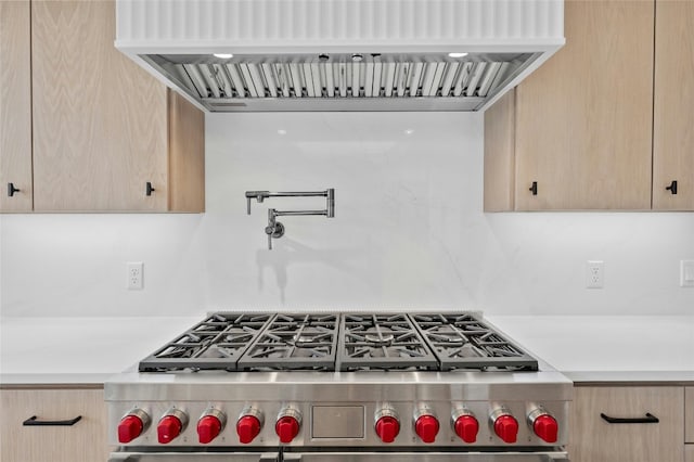 kitchen featuring decorative backsplash, high end stainless steel range, custom range hood, and light brown cabinets