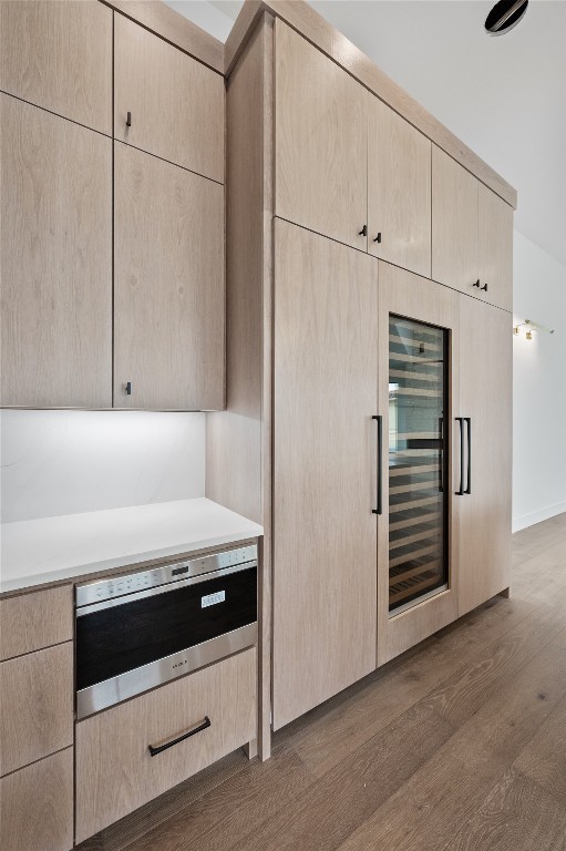 interior space with dark hardwood / wood-style floors and light brown cabinetry