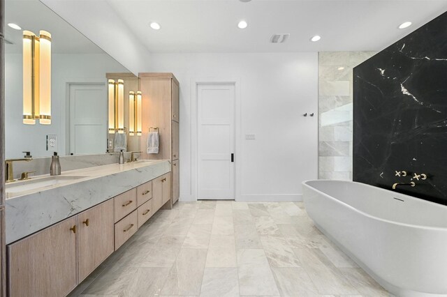 bathroom featuring a tub to relax in and vanity