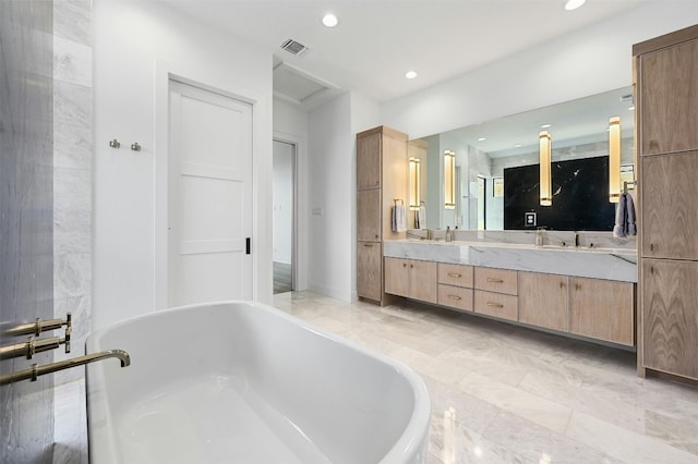 bathroom with vanity and a bathtub