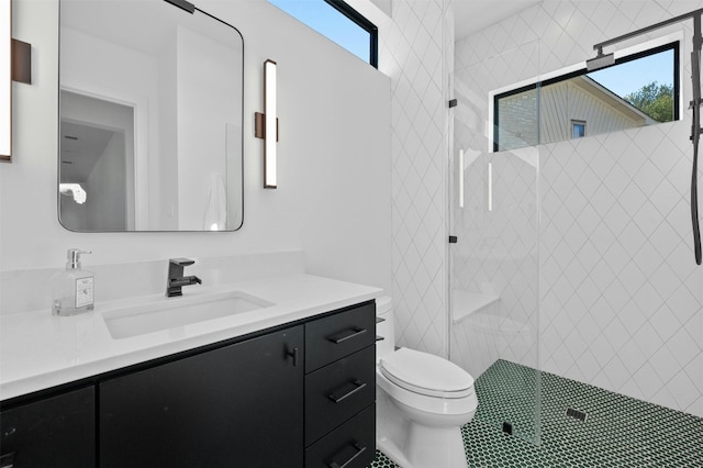 bathroom featuring an enclosed shower, vanity, a healthy amount of sunlight, and toilet