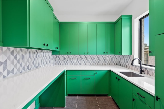 kitchen featuring sink, decorative backsplash, and dark tile patterned flooring