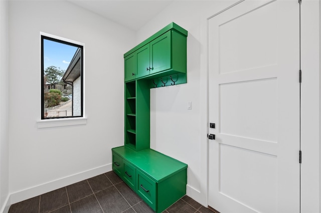 mudroom with dark tile patterned flooring