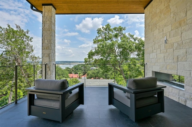 balcony with a patio area and a water view