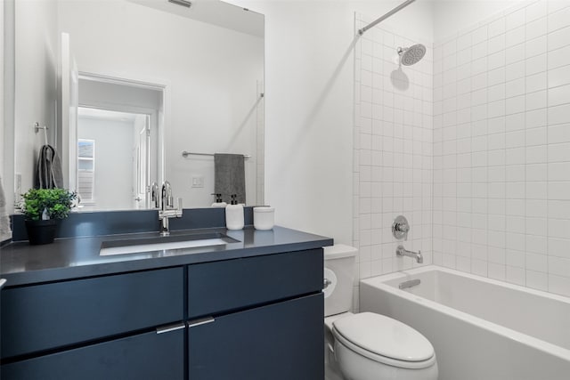 full bathroom featuring vanity, toilet, and tiled shower / bath