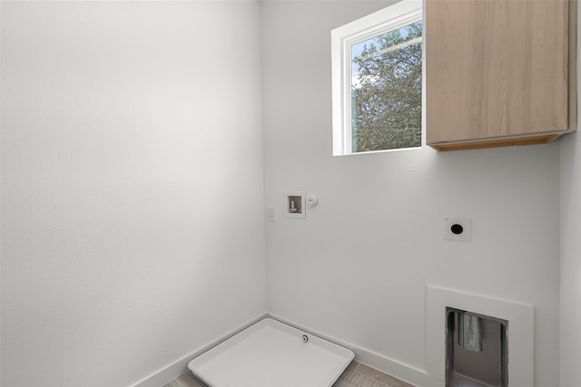 laundry room with hookup for a washing machine, hookup for an electric dryer, cabinets, and hookup for a gas dryer