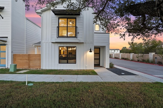 back house at dusk featuring a yard