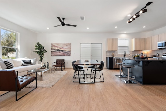 living room with rail lighting, sink, ceiling fan, and light hardwood / wood-style floors