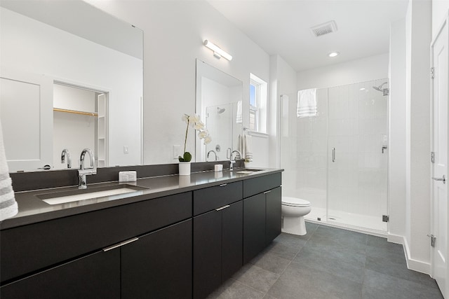 bathroom with a shower with door, vanity, and toilet