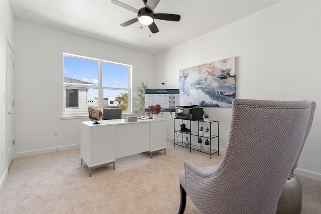 carpeted office space featuring ceiling fan