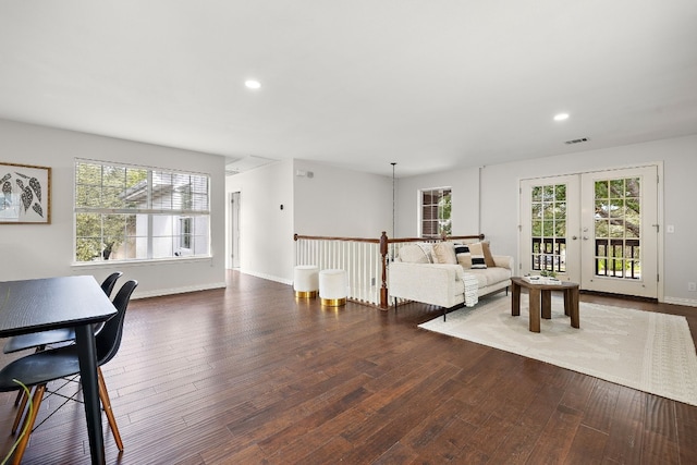 living room with french doors and dark wood-type flooring