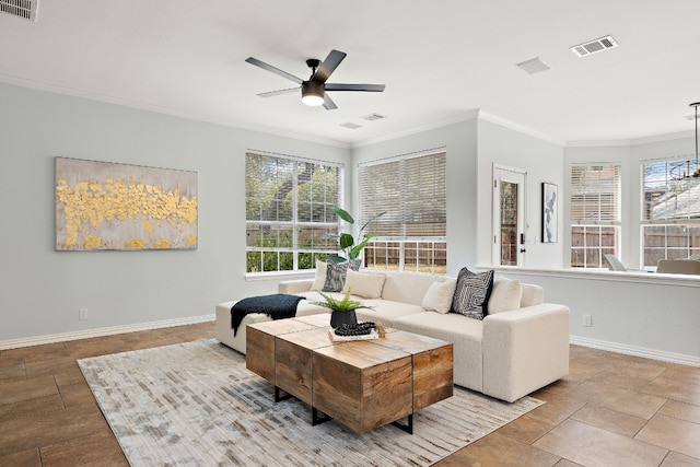 living room with ceiling fan and ornamental molding