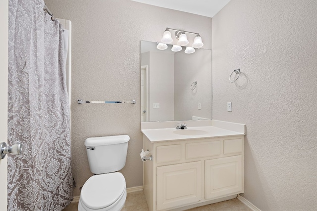 bathroom featuring curtained shower, vanity, and toilet