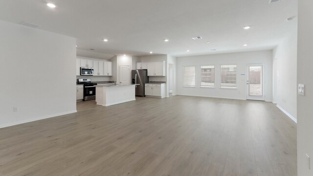 unfurnished living room featuring light hardwood / wood-style flooring