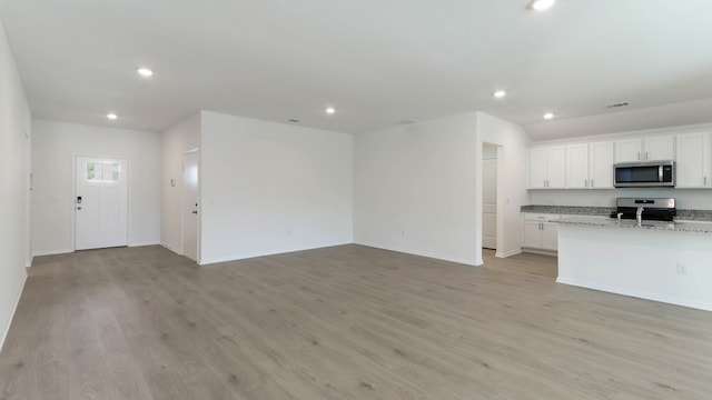 unfurnished living room featuring light hardwood / wood-style flooring