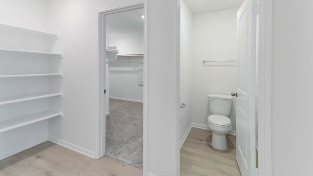 bathroom with toilet and hardwood / wood-style flooring