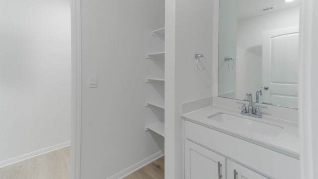 bathroom with vanity and hardwood / wood-style floors