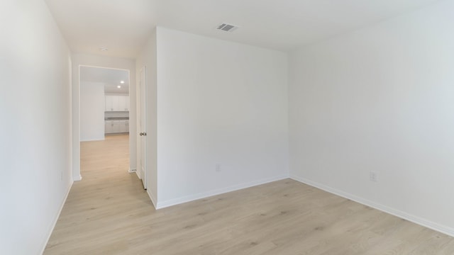 empty room with light hardwood / wood-style flooring