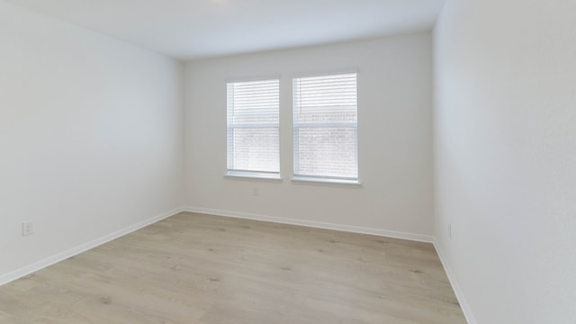 spare room with light hardwood / wood-style flooring