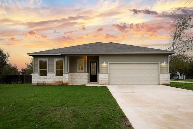 prairie-style house with a yard and a garage