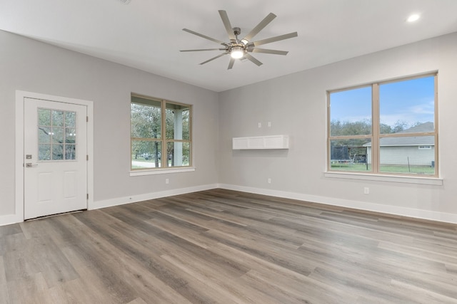 interior space featuring wood-type flooring and ceiling fan