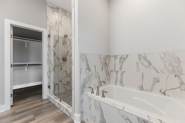 bathroom with wood-type flooring and separate shower and tub